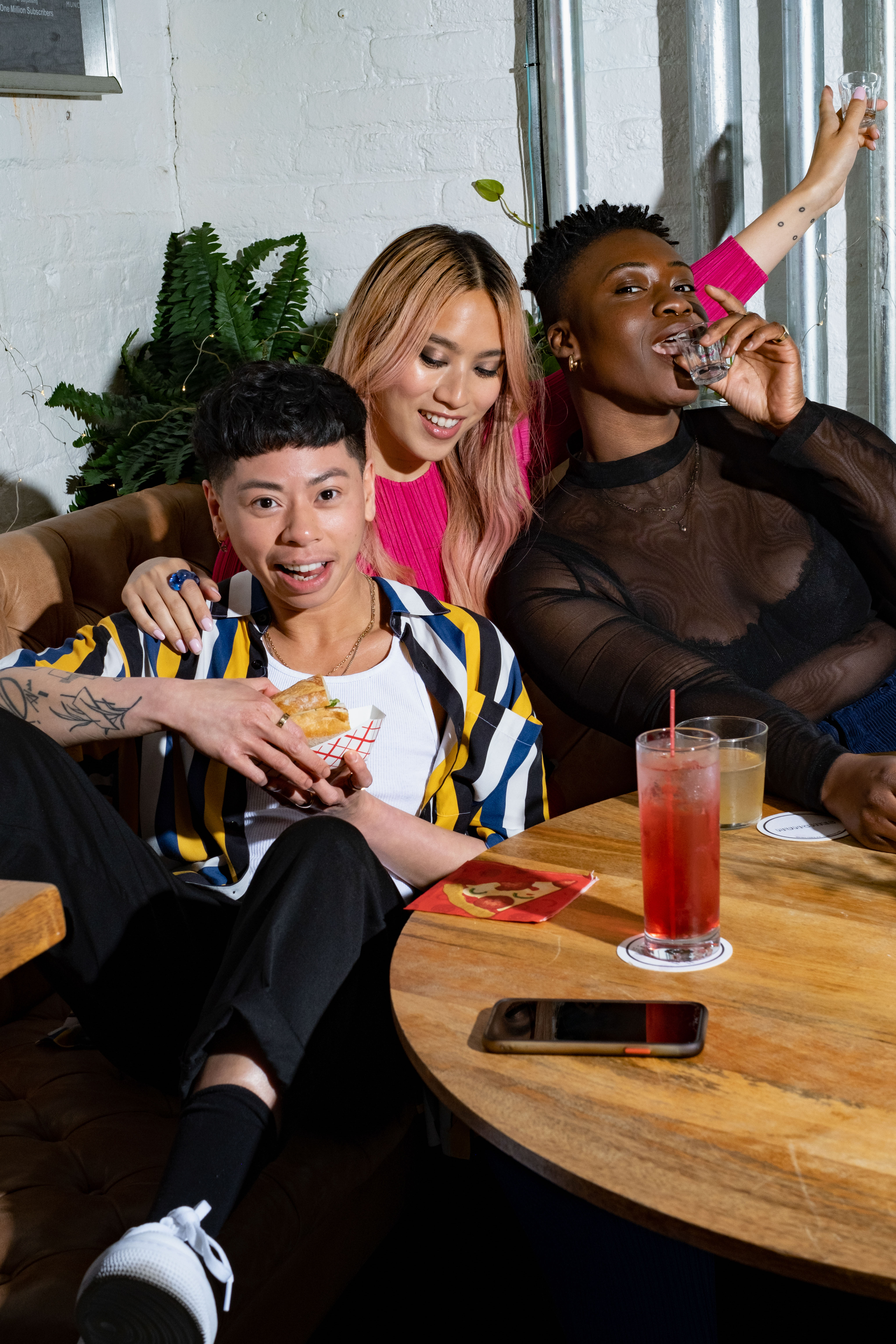 A group of friends of varying genders laughing over drinks(1)